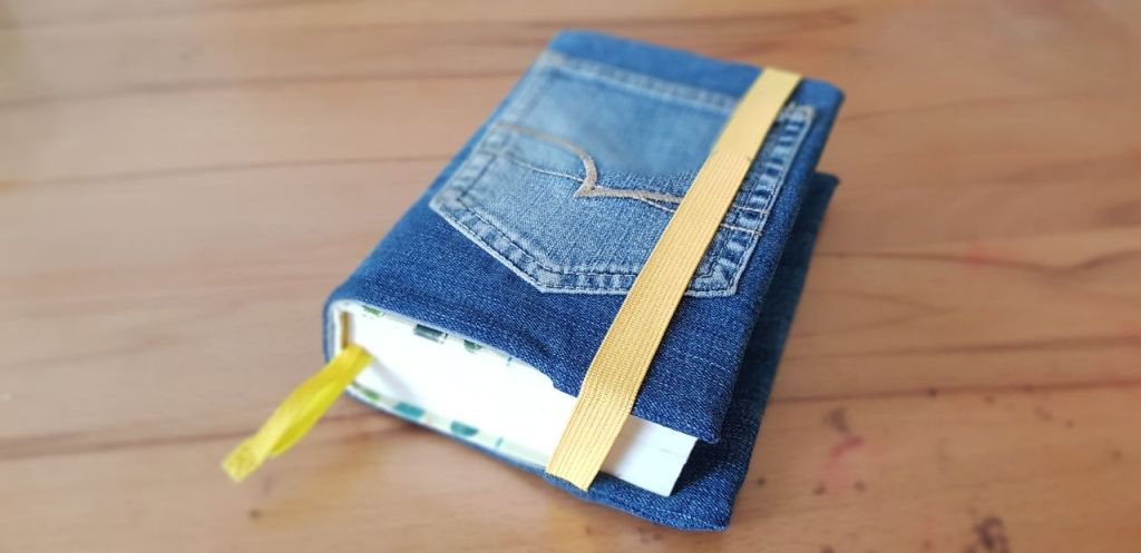 closed bible with a cover made from a pair of jeans